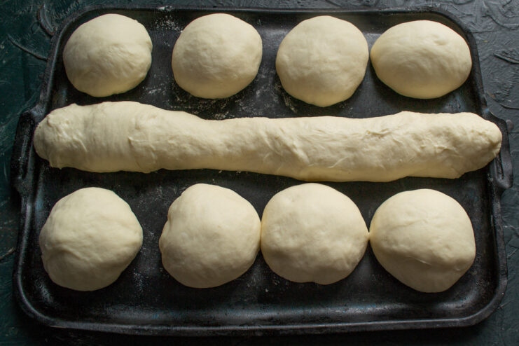 Proofed Vatrushki Buns Ready for Filling Puffy, proofed dough buns on a baking sheet, ready to be filled.