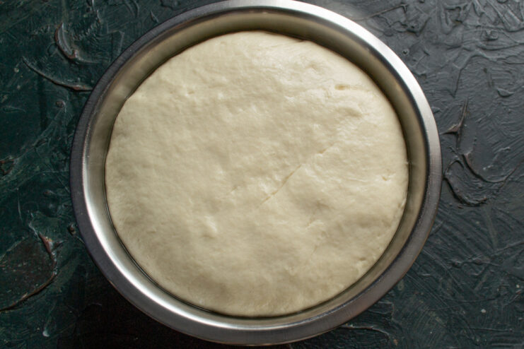Perfectly Risen Dough for Vatrushki The dough has risen significantly, filling the glass bowl after one hour.