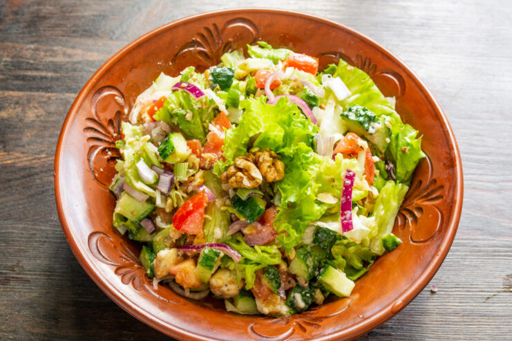 Serving suggestions for the vegan walnut and tofu salad. The finished vegan salad served in a bowl, ready to be eaten with a side of bread.