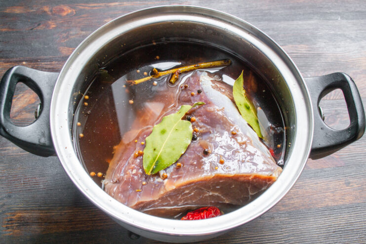 The 48-Hour Marination Process for Maximum Flavor Beef tenderloin marinating in a pot of spiced brine.