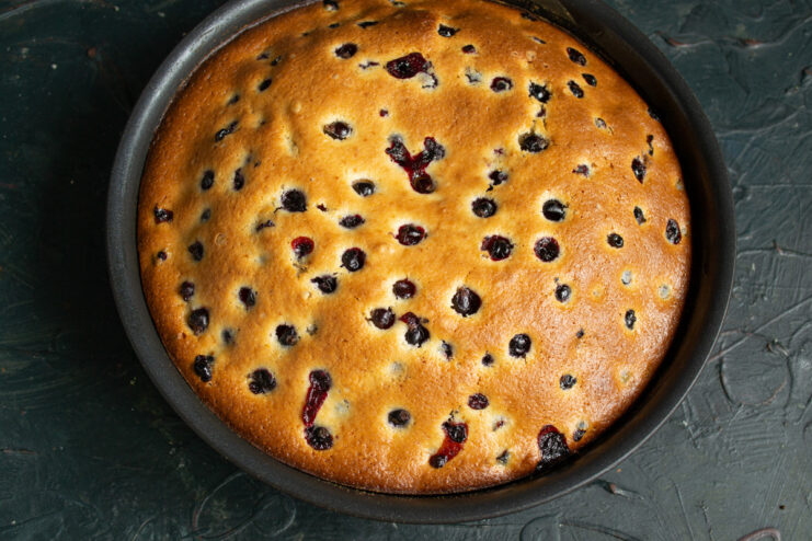Step 10: Baking the blackcurrant cake in the oven The pan with the blackcurrant cake batter placed on the middle rack of a preheated oven.