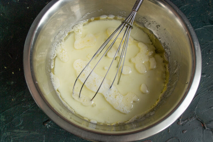 Step 3: Adding milk to the cake batter Pouring cold milk into the bowl with the wet cake ingredients.