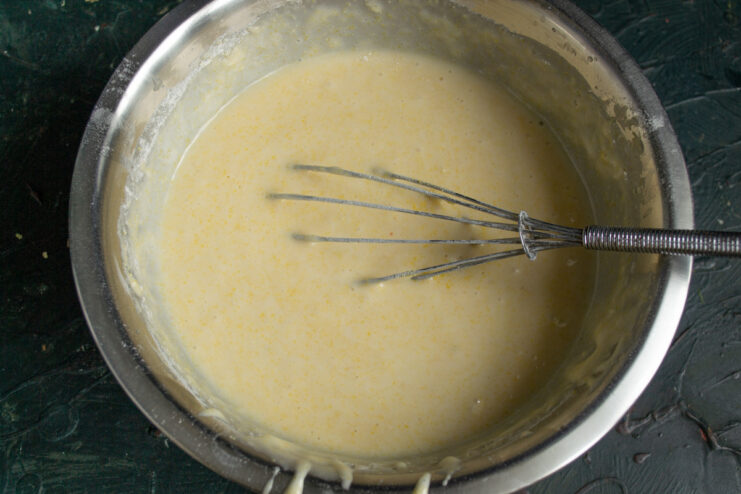Step 6: The finished smooth cake batter A bowl of smooth, pale yellow cake batter, mixed and ready for the berries.