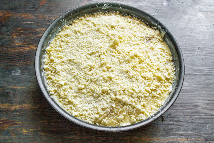 Step 11: Sprinkling the streusel over the pie before baking Sprinkling the streusel crumble evenly over the top of the pie batter.