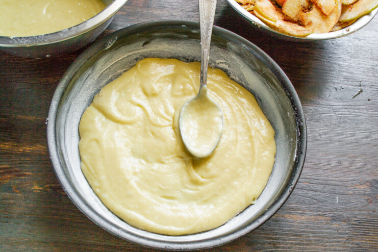 Step 7: Spreading the first layer of batter in the pan Spreading half of the pie batter evenly in the prepared baking dish.
