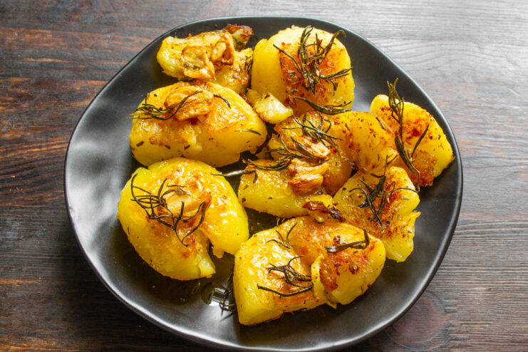 A close-up of the finished golden-brown roasted potatoes in the pan.