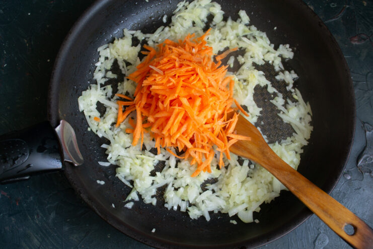 Sautéing Onions for the Savory Filling Chopped onions being added to a skillet with melted butter and oil.