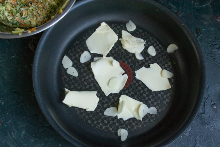 Preparing Garlic for Aromatic Flavor Garlic cloves being thinly sliced on a cutting board.