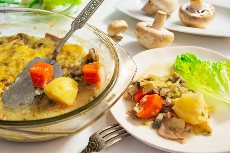 A golden-brown turkey and potato casserole in a baking dish, ready to be served.