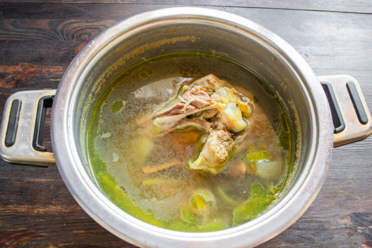 How to Make a Flavorful Turkey Broth for Your Casserole Turkey parts, carrots, onion, and celery in a pot with water to make broth.