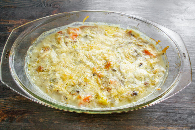 Baking the Casserole Until Golden and Bubbly The assembled casserole with a cheese topping ready to go into the oven.