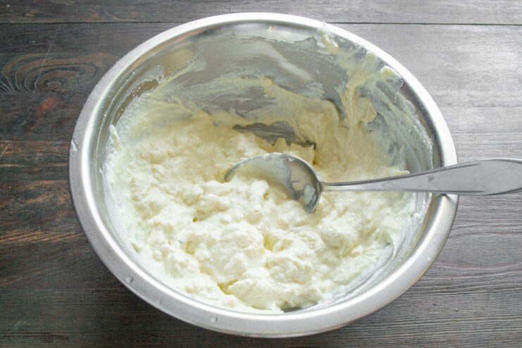 The final batter with lavash pieces resting in the bowl before baking. The complete zapekanka batter with pieces of lavash mixed in, resting in a white bowl.