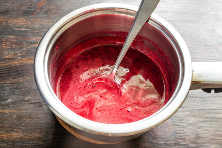 Preparing pectin to add to the fruit puree A small white bowl with pectin and sugar being mixed together.
