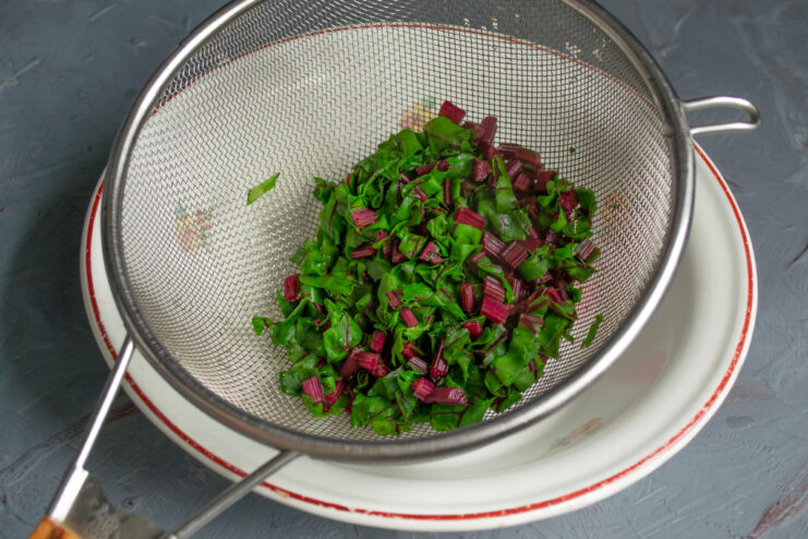 Scalding the Beet Greens Beet greens in a colander after being scalded