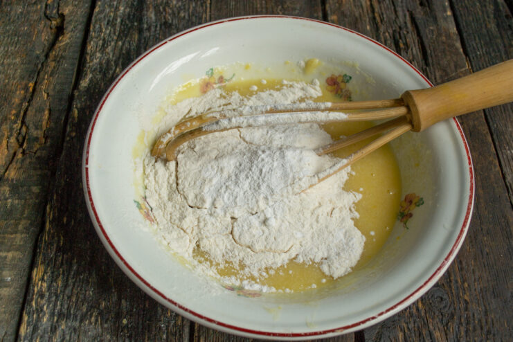 Adding dry ingredients Whole wheat flour and baking powder added to the mixing bowl