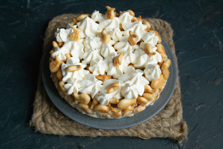 Garnishing with extra crackers Decorating the top of the cake with piped whipped cream and small fish crackers