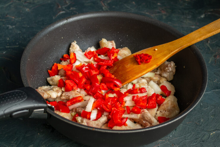 Vegetables For The Paprikash Adding diced red bell peppers and chili to the skillet