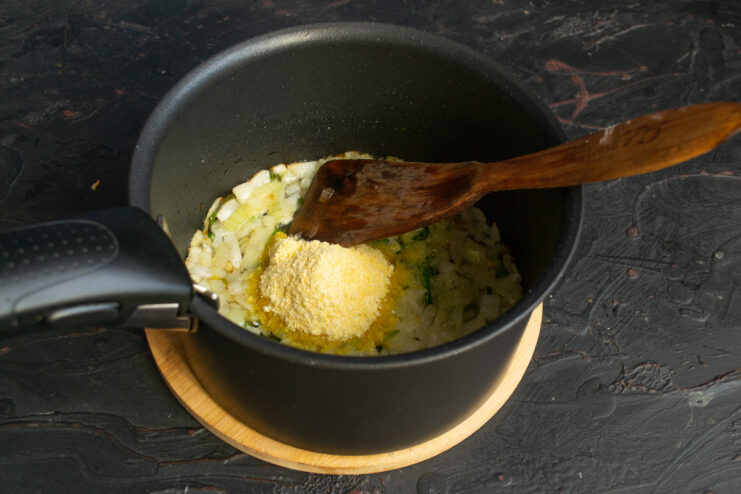 Thickening the Soup With Cornmeal Adding cornmeal to the vegetables in a pot