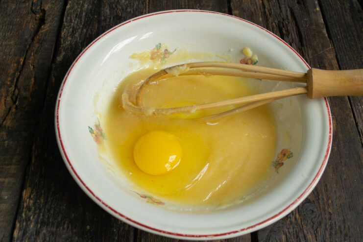 Adding the egg to the batter Adding a fresh egg and salt into the sweet lemon mixture