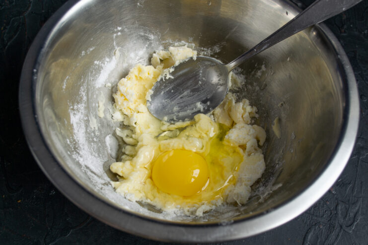 Adding the Egg Adding a fresh egg to the creamed butter and sugar mixture