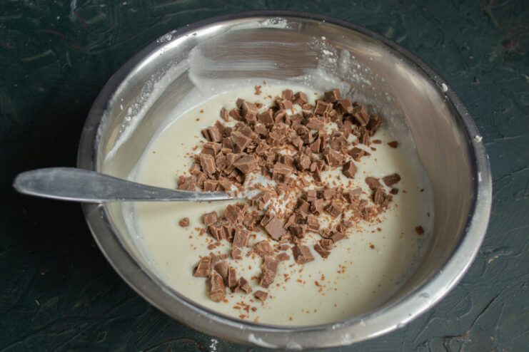 Folding in Chocolate Chunks Folding small cubes of milk chocolate into the light and creamy cheese filling