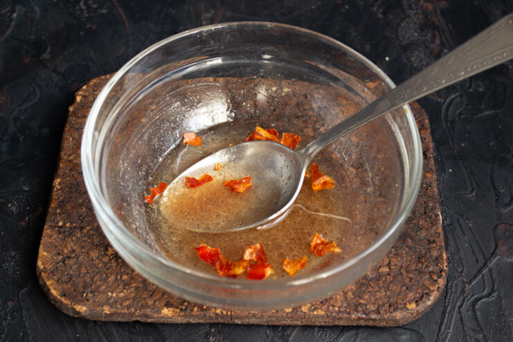 Adding Mild Heat Adding crumbled dried chili flakes into the dressing bowl