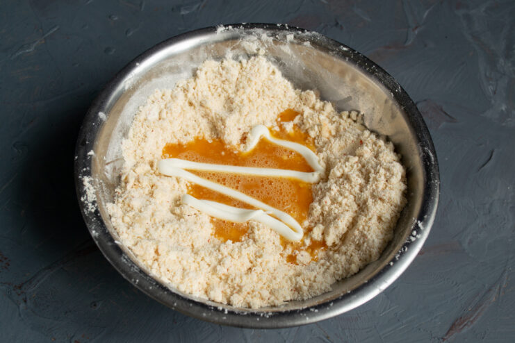 Adding mayonnaise for a tender dough Adding a spoonful of mayonnaise to the cookie dough mixture
