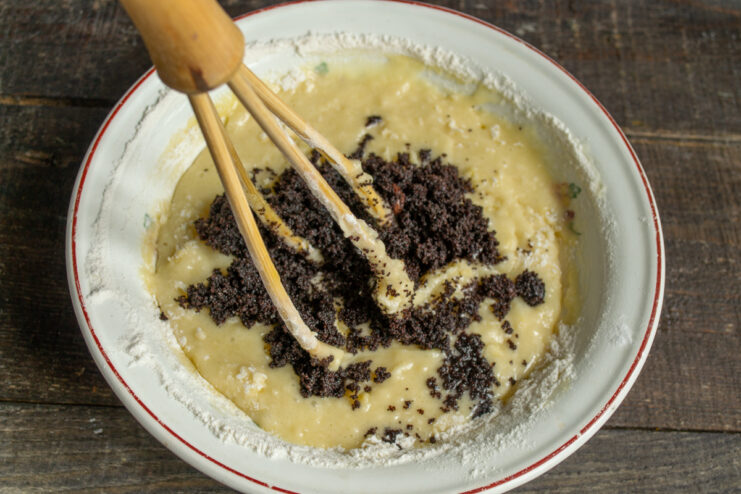 Adding the poppy seeds Folding poppy seed filling into the cake batter