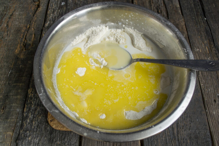 Combining Wet and Dry Components Pouring milk and melted butter into the dry cake mix