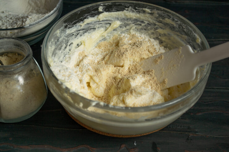 Adding spices Adding ground ginger to the shortbread dough