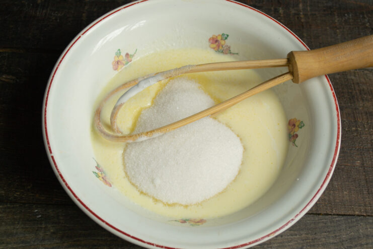 Adding the sugar Adding sugar and vanilla to the egg and kefir mixture