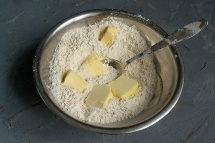 Butter and flour mixture Adding diced cold butter to the bowl of seasoned flour