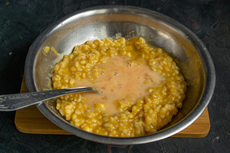 Binding the filling Adding a raw egg into the rice mixture to bind the filling.