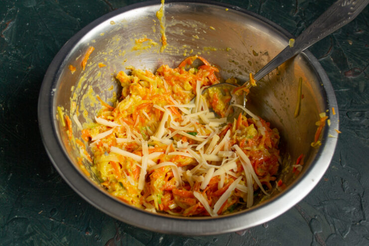 Adding grated cheese into the mixing bowl