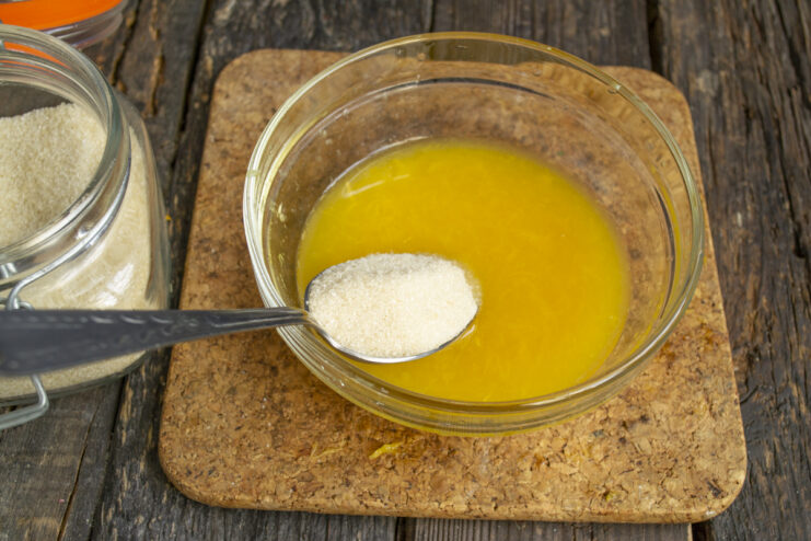 Mixing Juice With Sugar Adding cane sugar to fresh orange juice