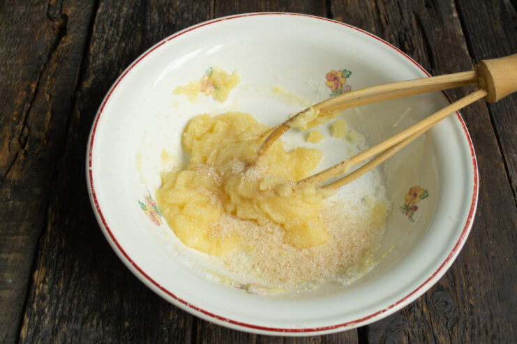 Mixing sugar and puree Adding brown cane sugar to lemon puree in a bowl