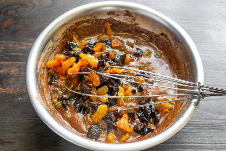 Folding In Dried Fruits Adding soaked prunes and raisins to the chocolate batter