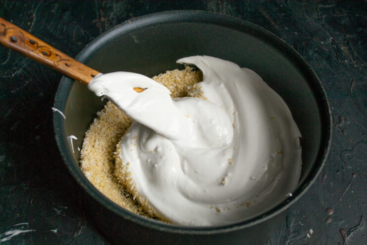 Folding stiff egg white meringue into the nut mixture