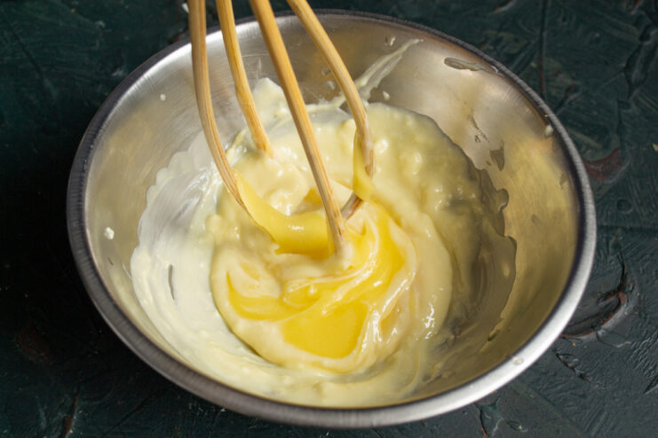 Adding The Honey Pouring liquid floral honey into the whipped butter mixture