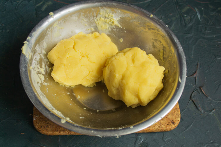 Dividing the dough Two portions of shortcrust pastry sitting in a bowl