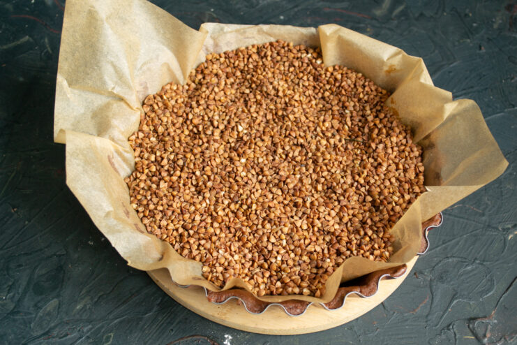 Blind Baking the Crust Baking pan lined with parchment paper and filled with raw buckwheat as pie weights