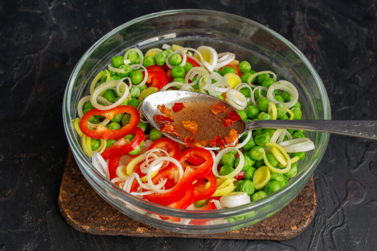 Whisking The Dressing Finished chili salad dressing in a small mixing bowl