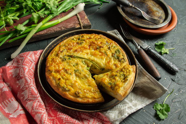 Baked smazhenka with cheese, rice, and herbs sliced into portions.