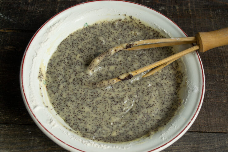 Batter consistency Thick poppy seed cake batter mixed in a bowl