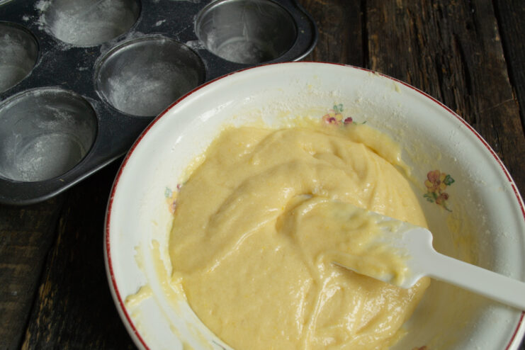 Finished batter texture Thick whole wheat lemon muffin batter mixed in a bowl