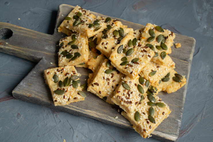 Serving the cookies Cooled savory cheese and seed cookies presented on a board