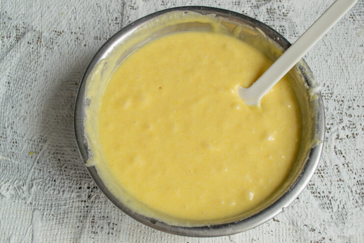 Resting the Batter Finished yellow cake batter resting in a bowl before baking.