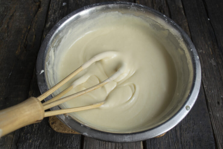 Smooth Batter Before Baking Smooth coconut cake batter in a mixing bowl