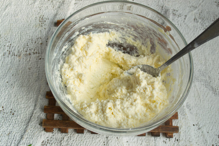 Finished Dough Texture Thick and sticky farmer's cheese dough in a mixing bowl