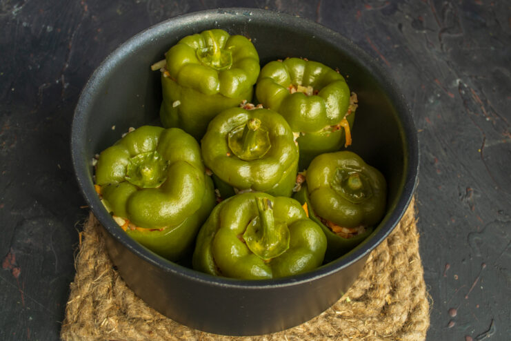 Finished dish in the pot Cooked stuffed bell peppers simmering in a pot
